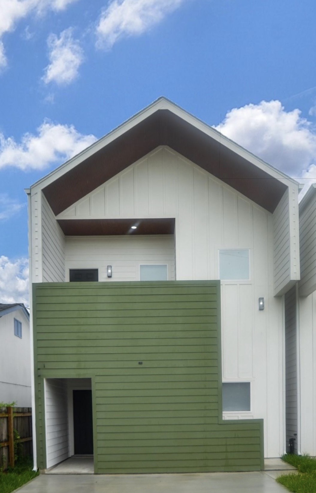 Clearwater duplex exterior with white siding and green accents